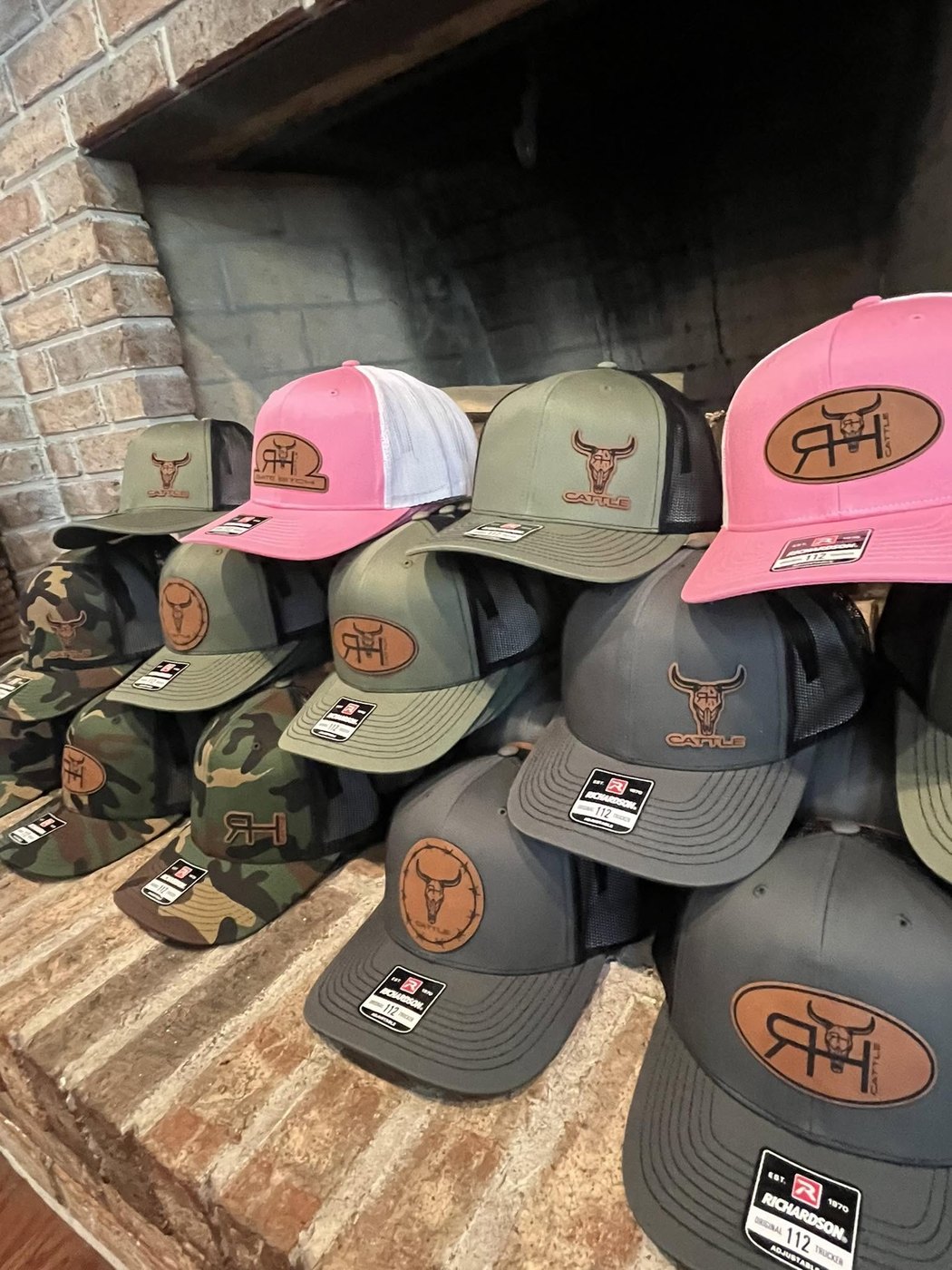 RH Cattle Co. leather patch hats stacked by the fireplace